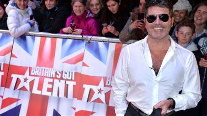 Simon Cowell breaks his back